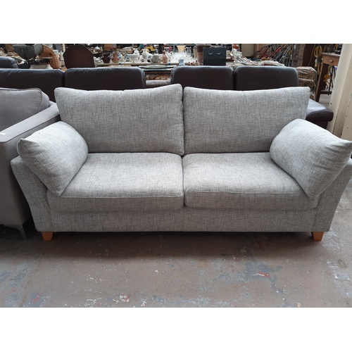 772 - A NEXT GREY UPHOLSTERED THREE SEATER SOFA ON SPLAYED SUPPORTS