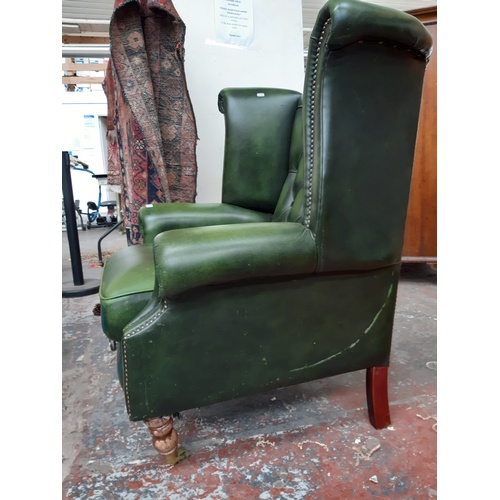 775 - A CHESTERFIELD STYLE GREEN LEATHER WING BACK ARMCHAIR