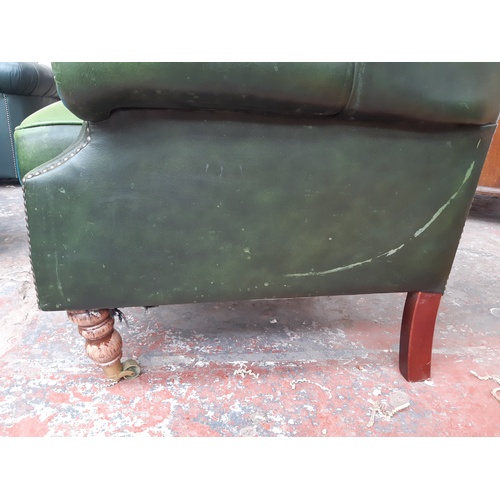 775 - A CHESTERFIELD STYLE GREEN LEATHER WING BACK ARMCHAIR