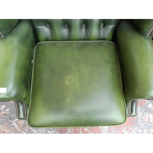 775 - A CHESTERFIELD STYLE GREEN LEATHER WING BACK ARMCHAIR