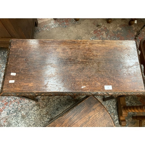 65 - A VICTORIAN HEAVILY CARVED OAK HALL TABLE WITH THREE DRAWERS EACH HAVING FOLIATE MASK DETAILING ON T... 