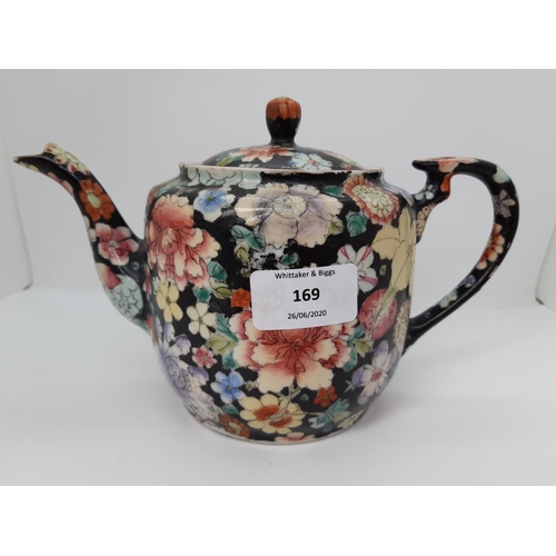 169 - A 19TH CENTURY QING DYNASTY BLACK HAND PAINTED FLORAL TEAPOT - MEASURING APPROX. 12CM HIGH