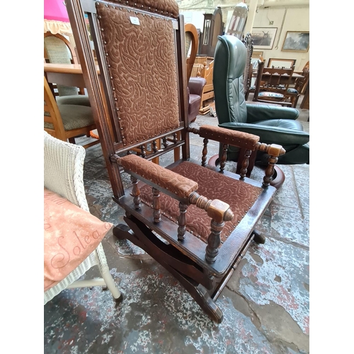 774 - A TURN OF THE CENTURY AMERICAN MAHOGANY FRAMED ROCKING CHAIR WITH BROWN UPHOLSTERED SEAT AND BACK