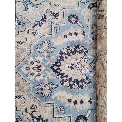 779 - A LARGE BLUE AND WHITE WOOL FARMHOUSE RUG