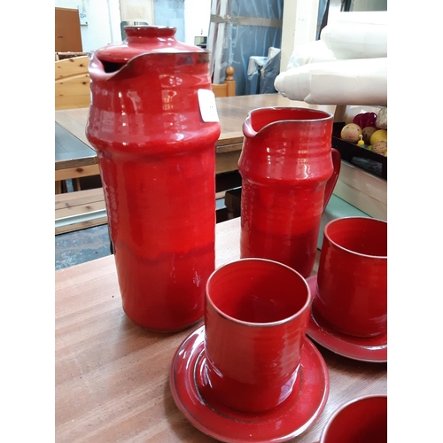 113 - A MID 20TH CENTURY FOURTEEN PIECE STUDIO CERAMIC COFFEE SET WITH RED PAINTED DRIP GLAZED EXTERIOR