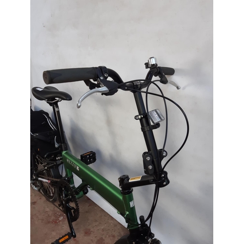 A BAGGED GREEN AND BLACK MEZZO D9 FOLDING BICYCLE WITH LIGHTWEIGHT