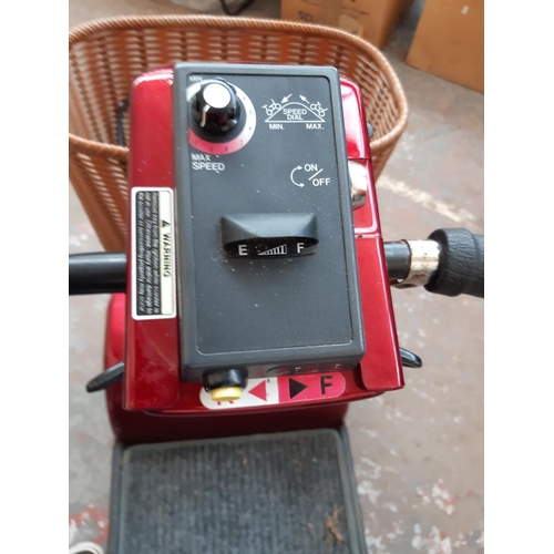 294 - A RED SHOPRIDER FOUR WHEELED ELECTRIC MOBILITY SCOOTER WITH BATTERY AND CHARGER (KEY IN OFFICE)