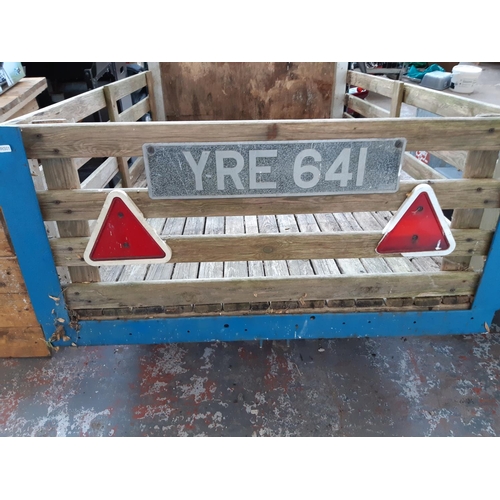 295 - A WOODEN SLATTED AND METAL TWO WHEEL CAR TRAILER - MEASURING APPROX. 5'6