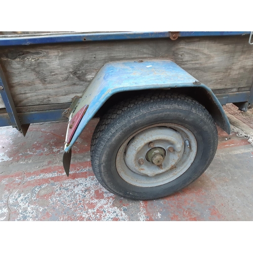 301 - A WOOD AND METAL TWO WHEEL CAR TRAILER - MEASURING APPROX. 8' X 4' X 12