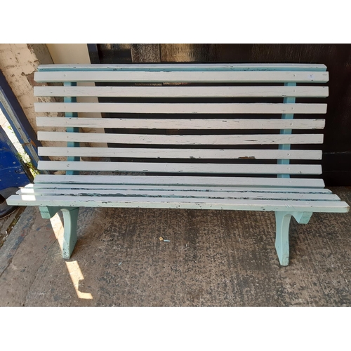 302 - A BLUE AND WHITE PAINTED WOODEN THREE SEAT GARDEN BENCH