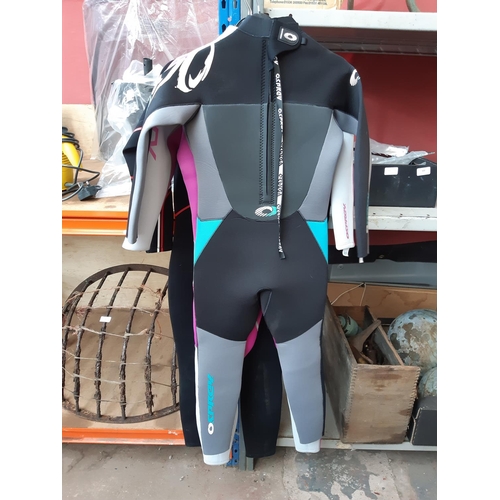 323 - FOUR WETSUITS TO INCLUDE A BLUE CHILD'S OSPREY, A BLACK ADULTS TWO BARE FEET AND TWO ADULT MULTI COL... 