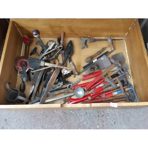 445 - A LARGE WOODEN BOX CONTAINING HAMMERS, CLIPPER HAND DRILL, WIRE BRUSHES, AXES ETC.