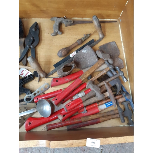 445 - A LARGE WOODEN BOX CONTAINING HAMMERS, CLIPPER HAND DRILL, WIRE BRUSHES, AXES ETC.