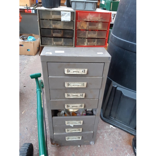 459 - THREE ITEMS TO INCLUDE A GREY METAL FILING CABINET CONTAINING VARIOUS CLOCK PARTS AND TWO SMALL PLAS... 