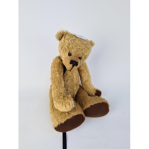 261 - A VINTAGE STYLE BLONDE TEDDY BEAR WITH BLACK RIBBON