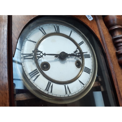 145 - A VICTORIAN MAHOGANY CASED CHIMING VIENNA WALL CLOCK WITH WHITE ENAMEL FACE, KEY AND PENDULUM