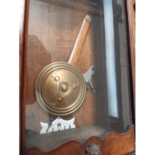 145 - A VICTORIAN MAHOGANY CASED CHIMING VIENNA WALL CLOCK WITH WHITE ENAMEL FACE, KEY AND PENDULUM