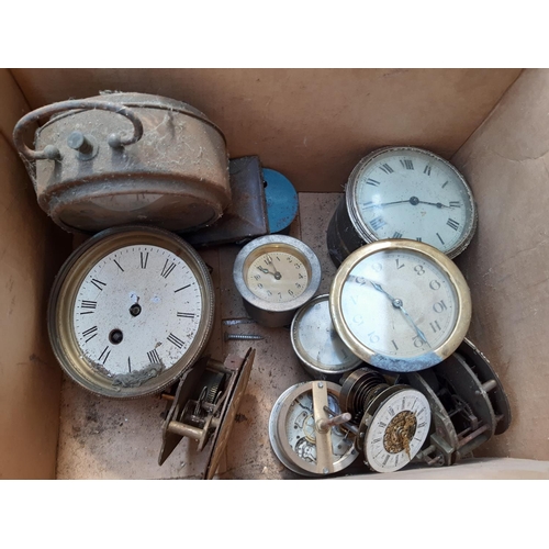 146 - A BOX CONTAINING A COLLECTION OF CLOCK ACCESSORIES TO INCLUDE MOVEMENTS, A SPELTER CLOCK SURROUND WI... 