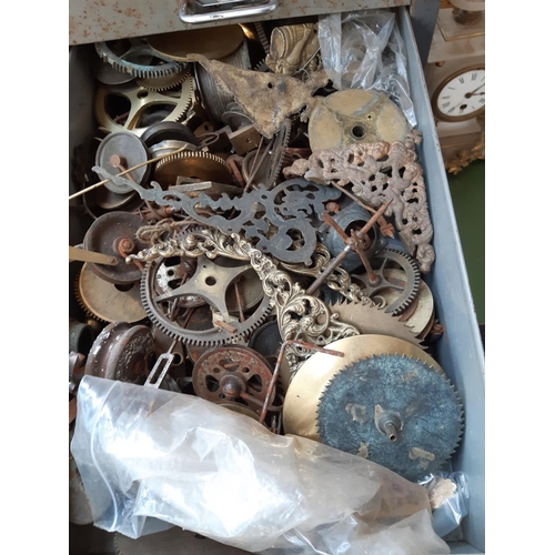 153 - A VINTAGE METAL EIGHT DRAWER FILING CABINET CONTAINING A LARGE COLLECTION OF WATCHMAKERS PARTS AND A... 