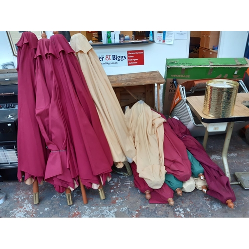 299A - A LARGE QUANTITY OF VARIOUS COLOURED GARDEN PARASOLS