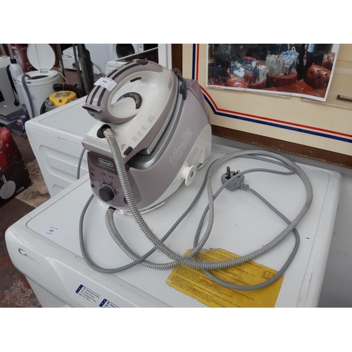 322 - A PURPLE AND WHITE DELONGHI STIRELLA STEAM IRON STATION