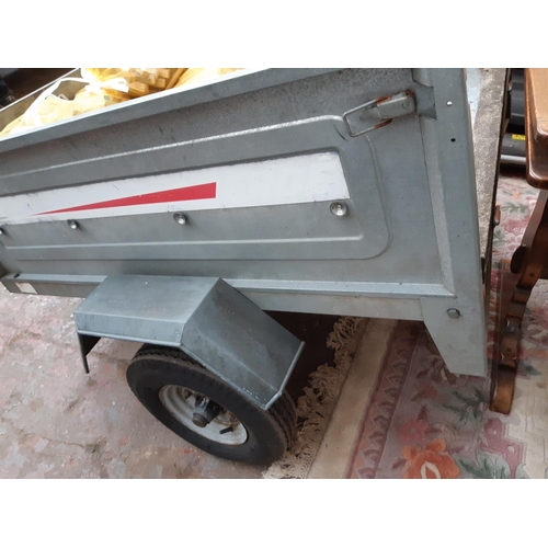 34 - AN ERDE 122 TWO WHEELED GALVANISED CAR TRAILER WITH LIGHTS - MEASURING APPROX. 4' X 3' X 14
