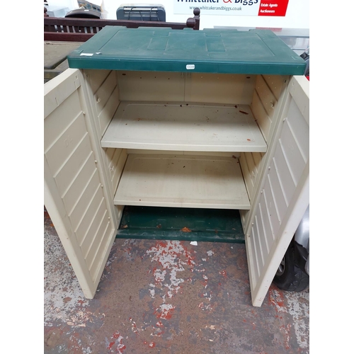 11 - A GREEN AND CREAM PLASTIC GARDEN STORAGE CABINET