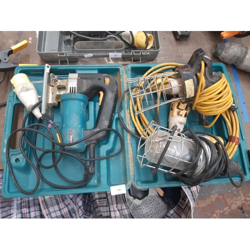 196 - THREE ITEMS TO INCLUDE A CASED MAKITA 110V JIGSAW AND TWO 110V WORK LIGHTS