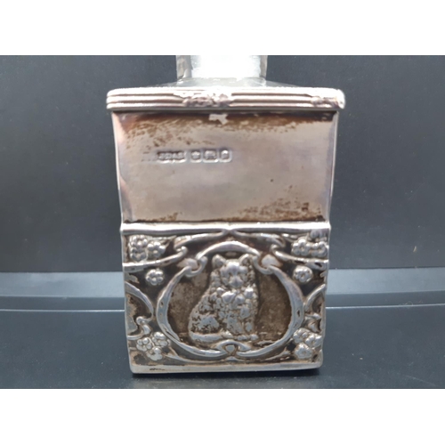 130 - A cut glass and hallmarked Sheffield silver perfume bottle with embossed cat design and original sto... 