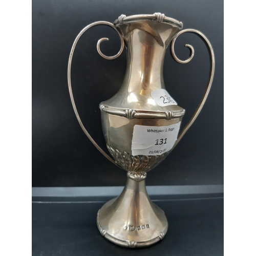 131 - A hallmarked Birmingham silver two handled trophy vase with repeated leaf design, weighted base and ... 
