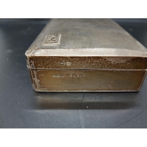 145 - A hallmarked Birmingham silver cigarette box with “EP” initials and engine turned top, dated 1937