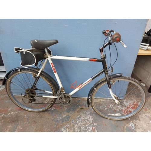 A black and white Raleigh Mustang gents touring bike with rear carrier and 15 speed gear system