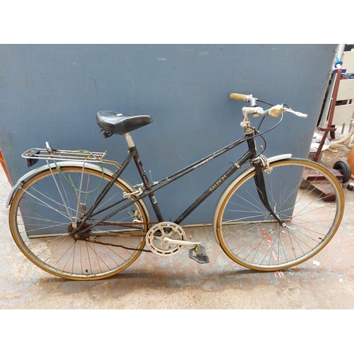 263 - A vintage black Raleigh Richmond ladies town bike with quick release front wheel, rear carrier and s... 