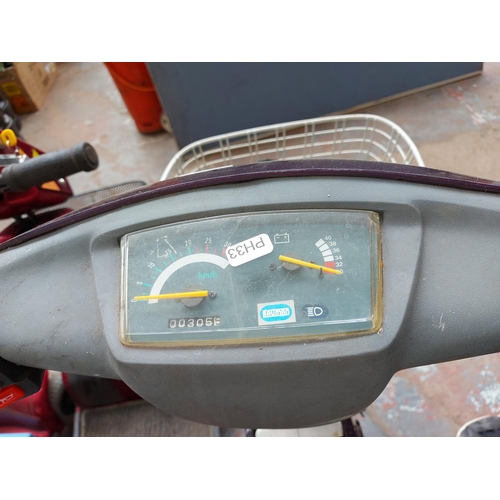 265 - A purple and grey Bouman electric scooter with front suspension, front and rear carriers, 305 miles ... 