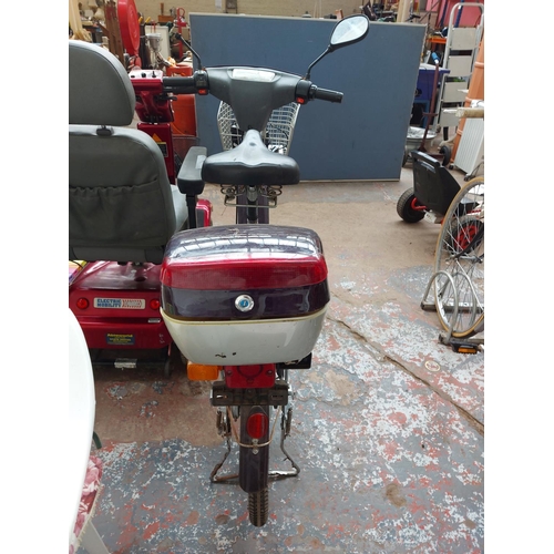 265 - A purple and grey Bouman electric scooter with front suspension, front and rear carriers, 305 miles ... 