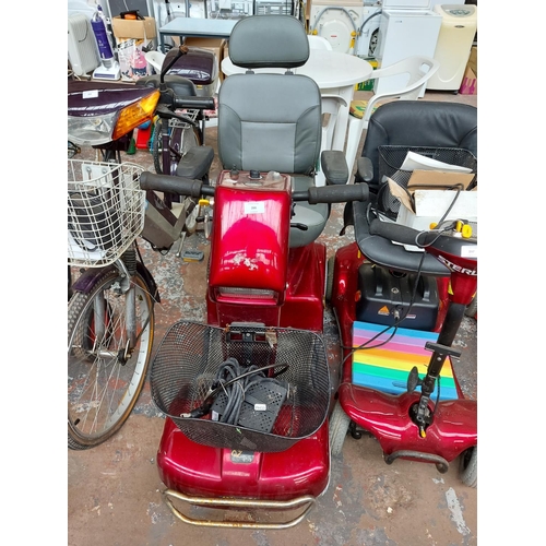 266 - A red Rascal ride on four wheeled mobility scooter with key, battery and charger (switches on, drive... 