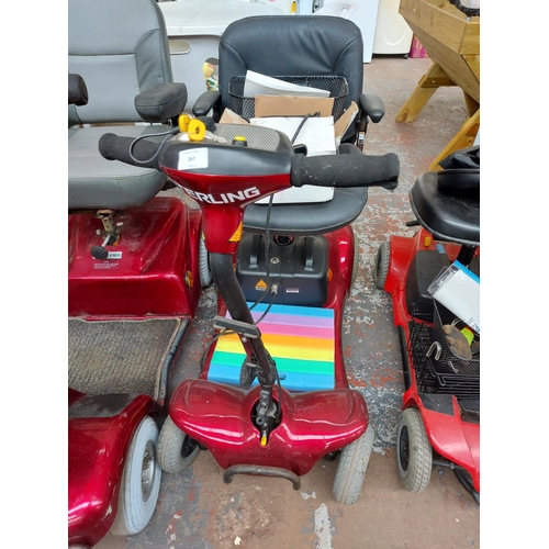 267 - A red Sterling Pearl four wheeled ride on mobility scooter with two keys, battery, charger and instr... 