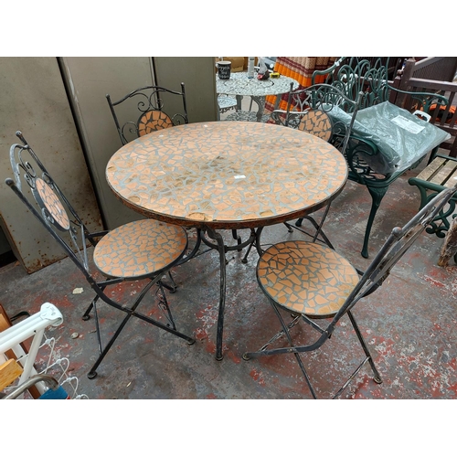 289 - A five piece good quality mosaic patio set comprising of circular table and four matching folding ch... 