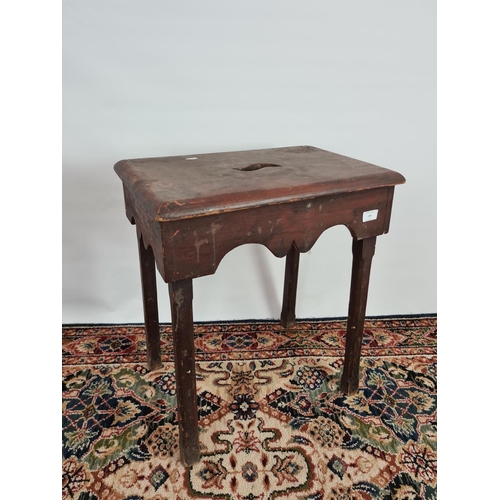 234 - An 18th century stained pine four legged tall farmhouse stool with central handle to top - measuring... 