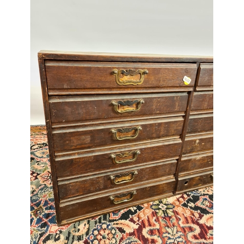 235 - An early 20th century oak twelve drawer index cabinet with brass handles - measuring approx. 78cm in... 