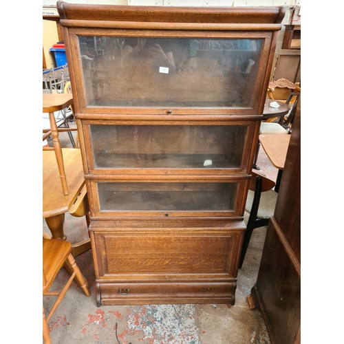 242 - An early 20th century oak Globe-Wernicke style four tier stacking bookcase with three glazed doors a... 