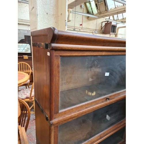 242 - An early 20th century oak Globe-Wernicke style four tier stacking bookcase with three glazed doors a... 