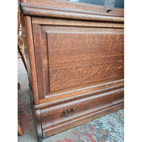 242 - An early 20th century oak Globe-Wernicke style four tier stacking bookcase with three glazed doors a... 