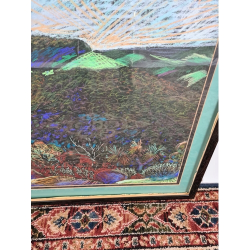 245 - A framed chalk picture of a multicoloured desert landscape in the style of William Crozier