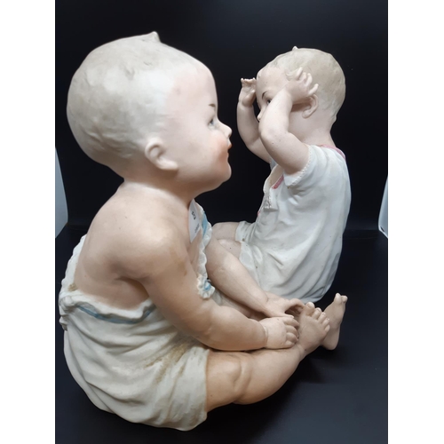 37 - A pair of Gebrüder Heubach of Licht and Sonneberg, Germany, Piano Baby figurines - Measuring approx.... 