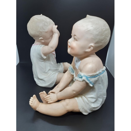 37 - A pair of Gebrüder Heubach of Licht and Sonneberg, Germany, Piano Baby figurines - Measuring approx.... 