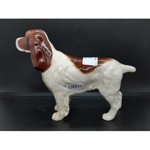 12 - A Beswick brown and white Cocker Spaniel figurine - No. 1754 (Measuring approx. 14cm tall)