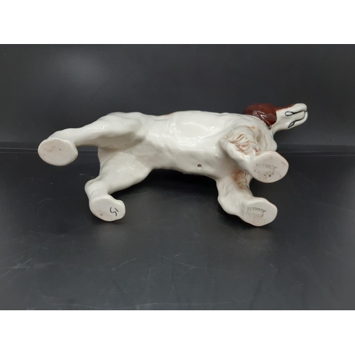 12 - A Beswick brown and white Cocker Spaniel figurine - No. 1754 (Measuring approx. 14cm tall)