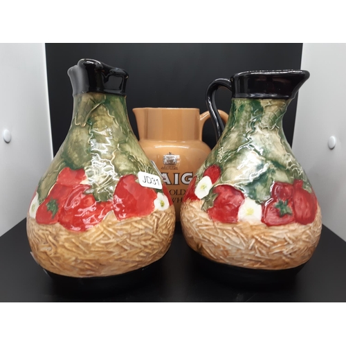 14 - Three ceramic jugs to include a pair of Peggy Davies jugs (Approx. 18cm tall) and a Carlton Ware 'Ha... 