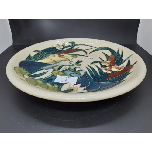 3 - A Moorcroft pottery plate in the lamia pattern   - measuring approx. 26.5cm in diameter